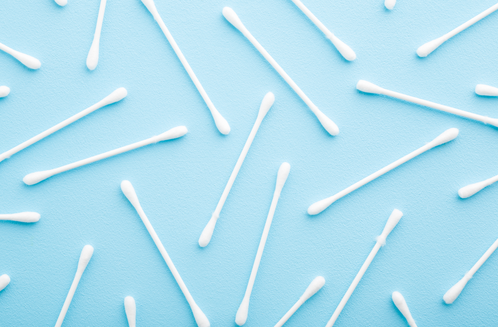 Cotton swabs against a blue background